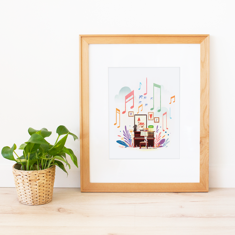 World of Music Large Print. Dimensions: 11 x 14 inch <br>Illustration features a little white cat seated at a dark wooden upright piano surrounded by colorful leafy shapes in blue, pink, and purple. Piano is surrounded by framed artworks and colorful pastel musical notes floating through the air above as the music is being played; white background. Each art print is printed on archival cotton paper and packaged flat in clear cellophane.